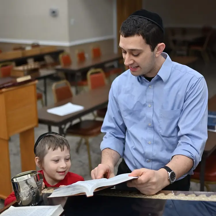 teacher and student reading a book
