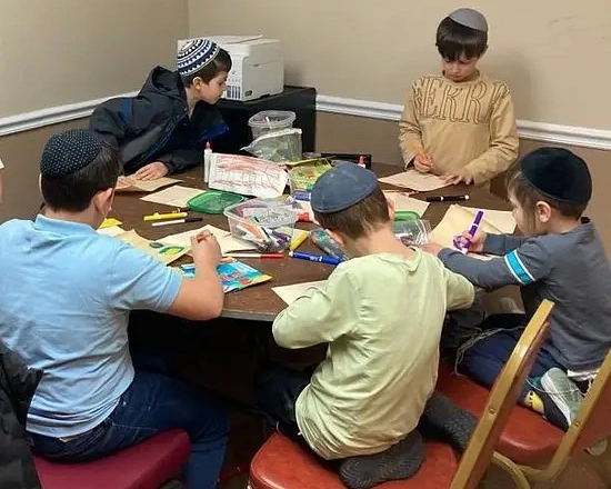 group of kids learning around table
